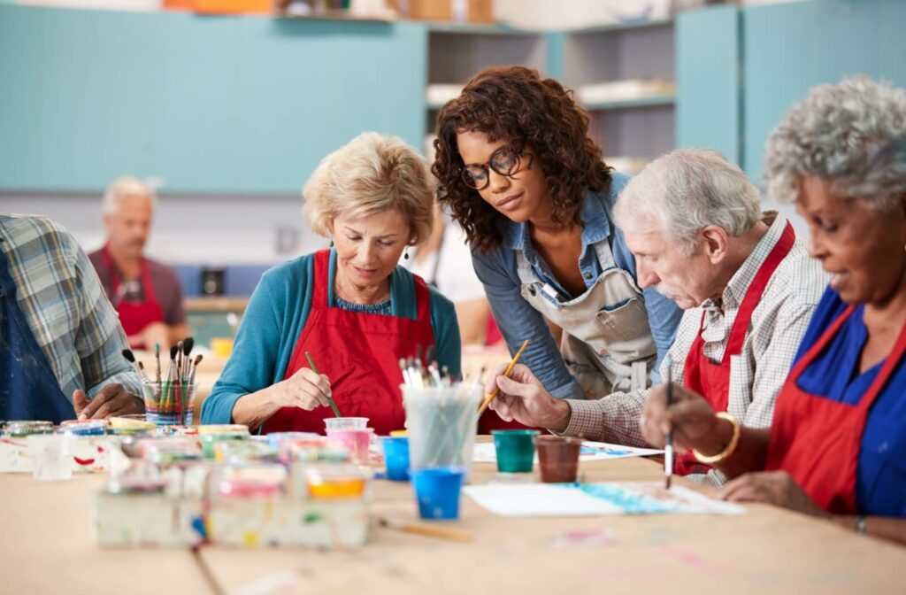 A group of residents in assisted living participating in a community-organized paint event.