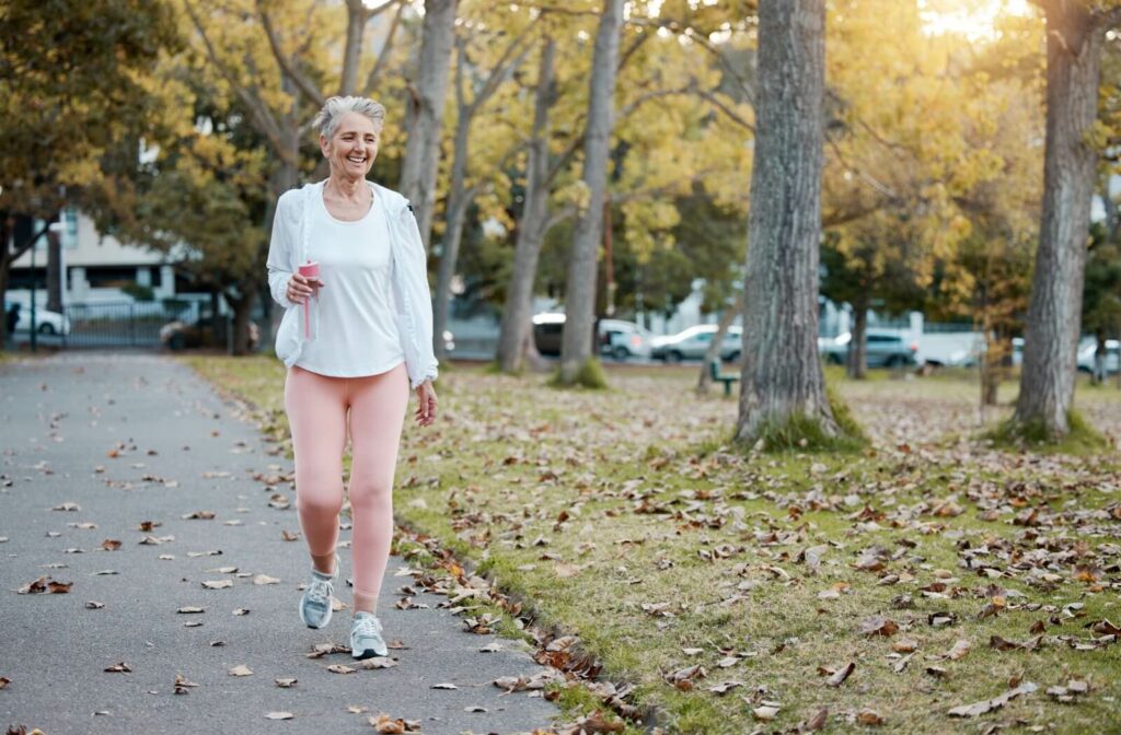 A senior takes a stroll outside during the autumn.